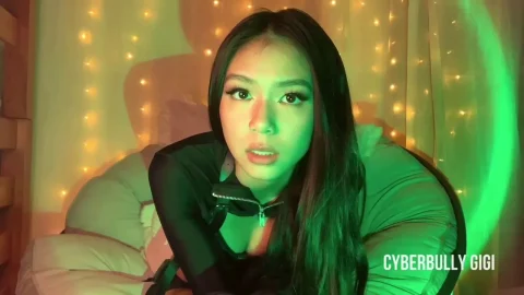 Asian girl in bedroom with gun and tablet, string lights vibe