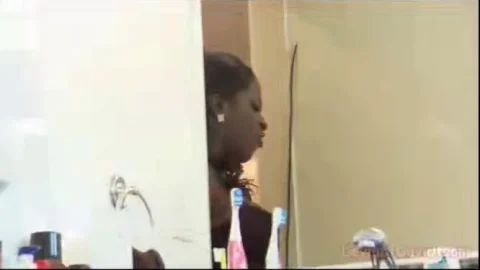 Black woman and white guy 69 on red couch, bathroom blowjob scene