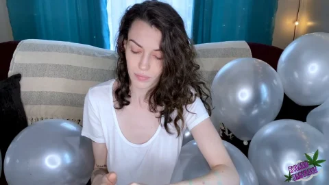 Ryland BabyLove – brunette inflating balloons with her mouth